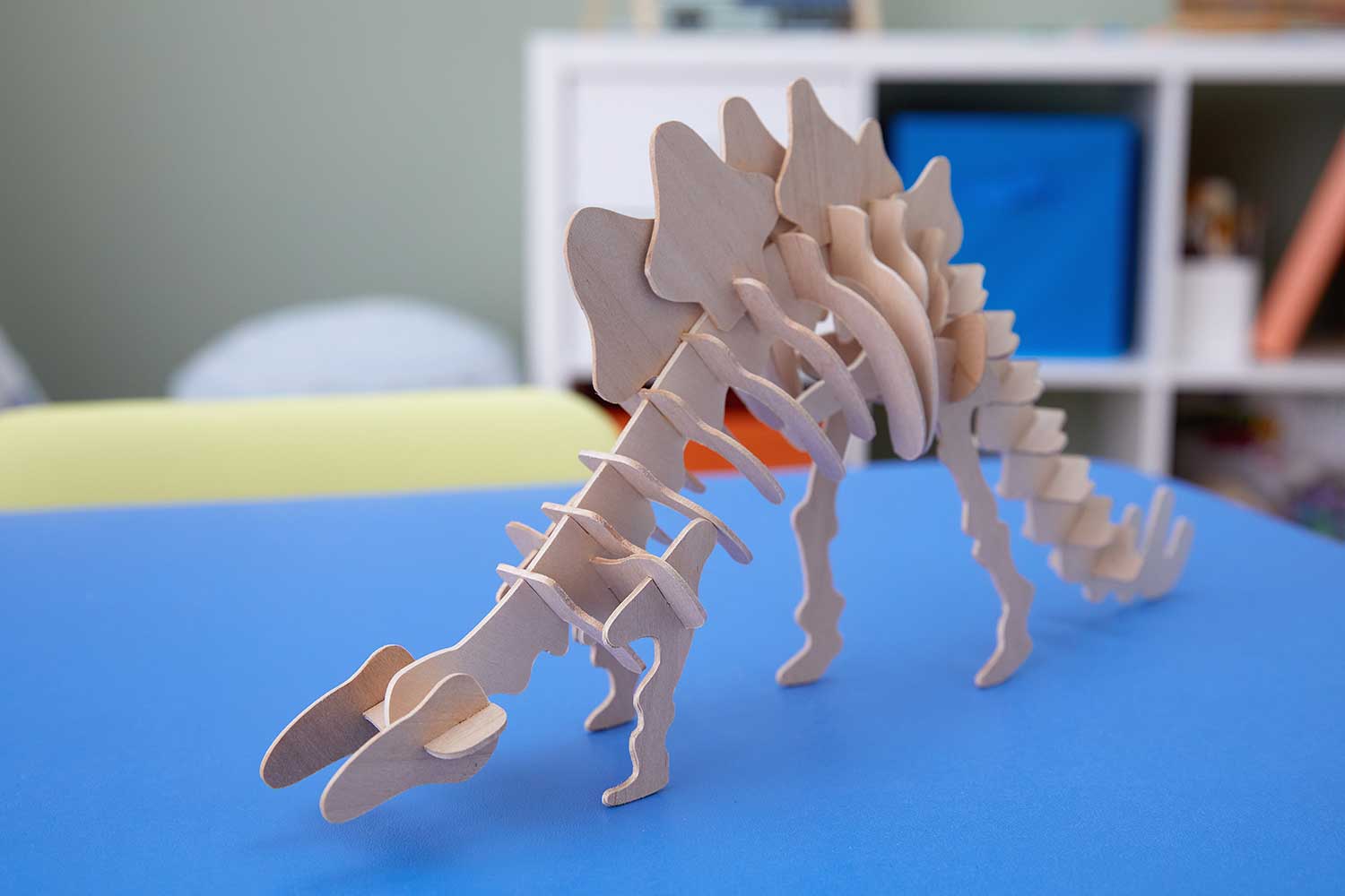 A wooden dinosaur skeleton that has been made using Cricut